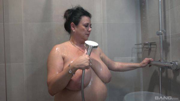 Busty nude mature showers and masturbates in a kinky combo on royalboobs.com